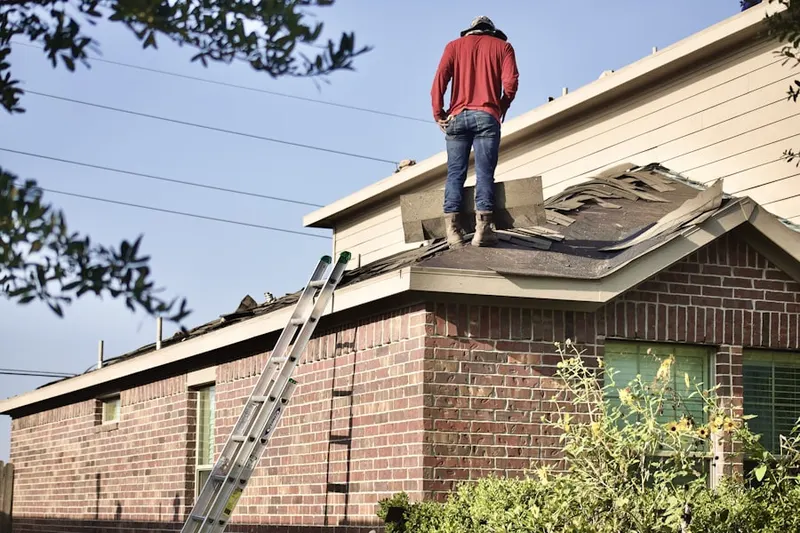 Professional roofer working on a residential roof in Roxborough Park